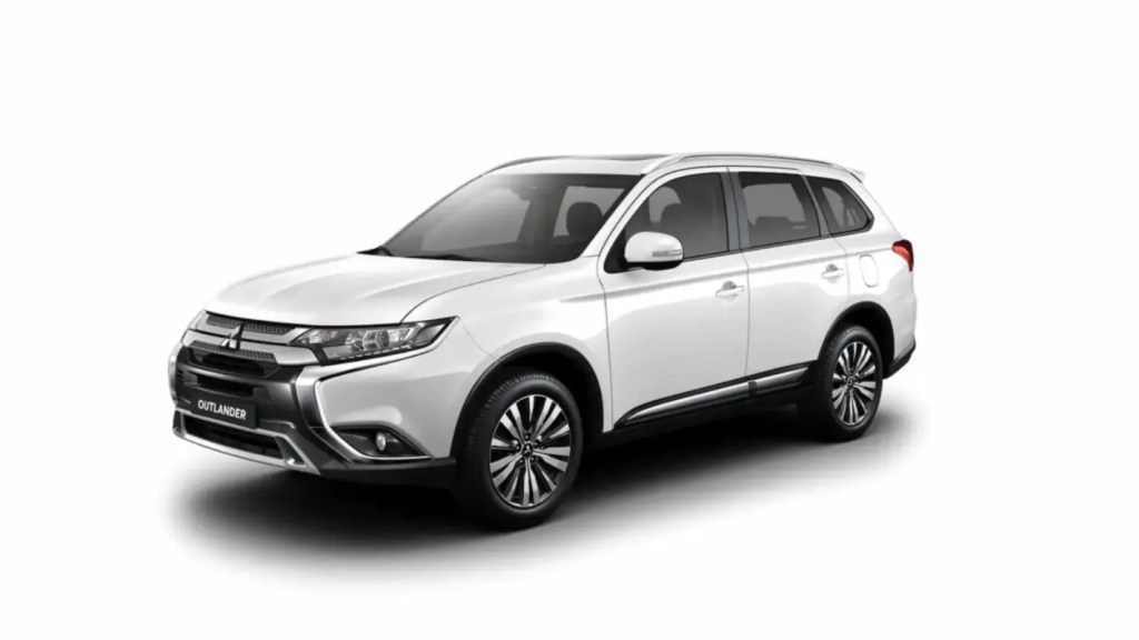 Carro SUV branco estacionado em fundo neutro.